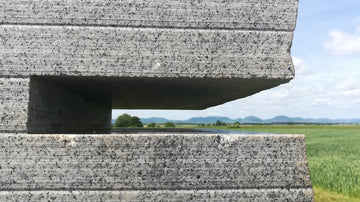 a close up of a building with grass in the background